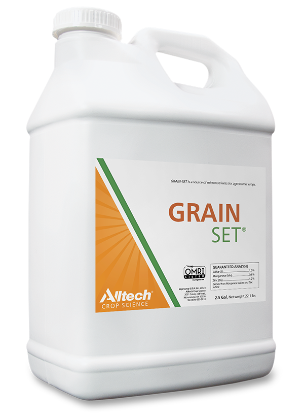 A white plastic container labeled "GRAIN SET" by Alltech Crop Science. The container has a handle and a clear, orange and green design. It includes a section for guaranteed analysis details, emphasizing its use for agriculture and crop enhancement.