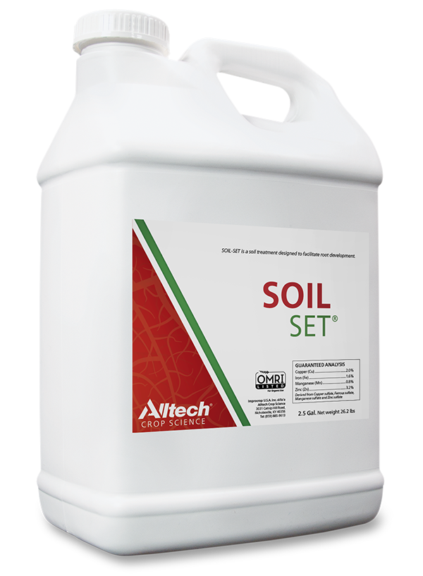 A white plastic jug labeled "SOIL SET" from Alltech Crop Science. The product is designed for soil treatment to enhance root development. The container holds 2.5 gallons and features a red and green design, including a note on OMRI certification.